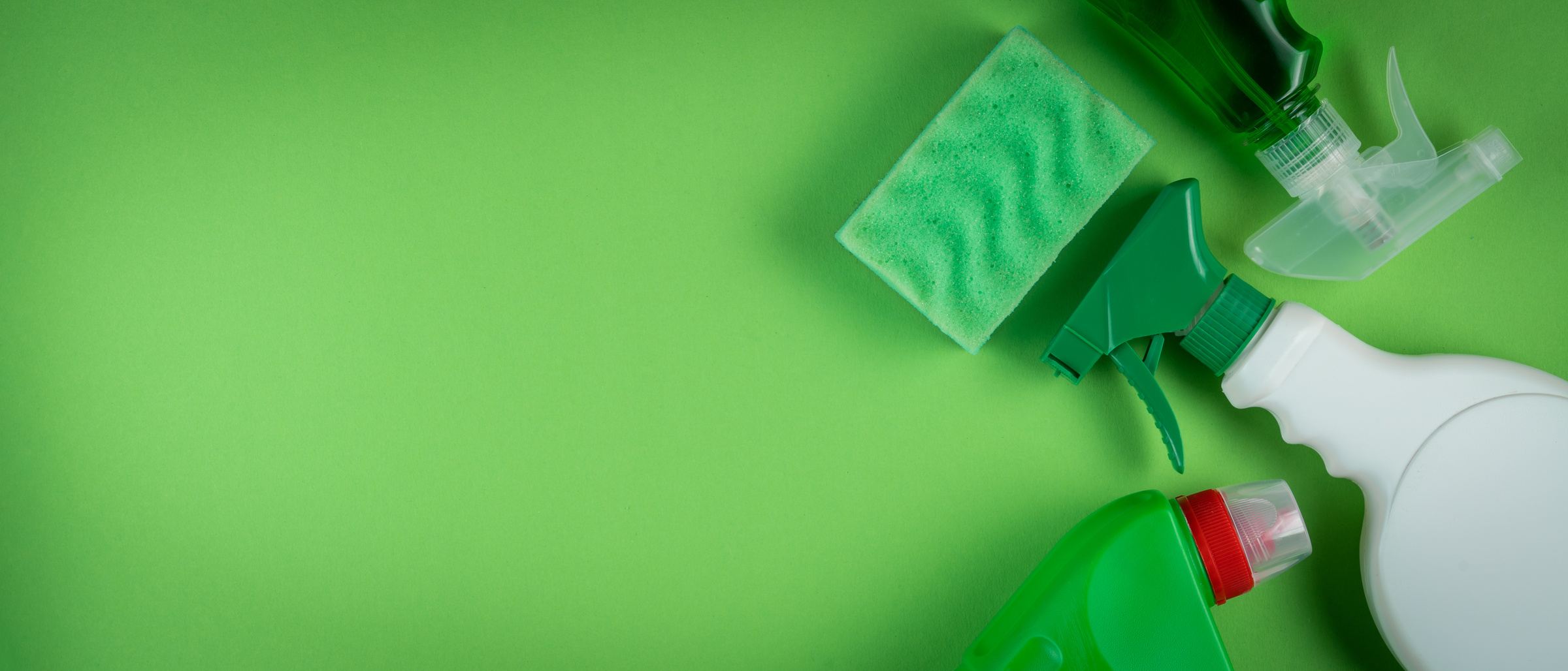 Cleaning supplies on green background